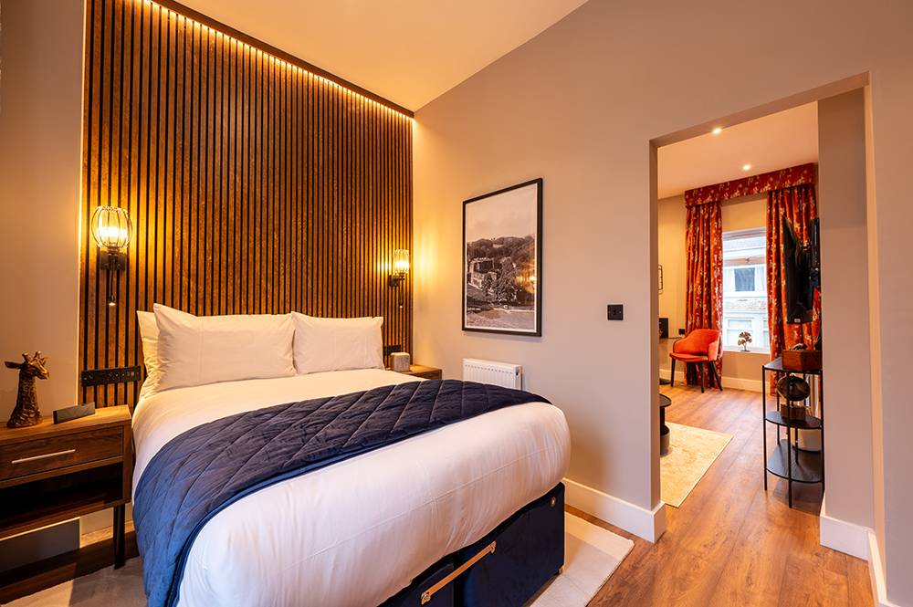 Sofa, coffee table, chairs and kitchen facilities in The Old Brewery, Barrow-in-Furness